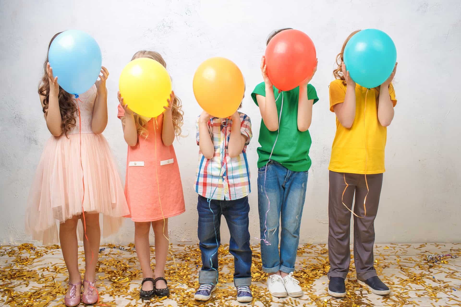 Children holding colorful balloons in a white background, image from the creativity and play category from Harvesting Happiness with Lisa Cypers Kamen.