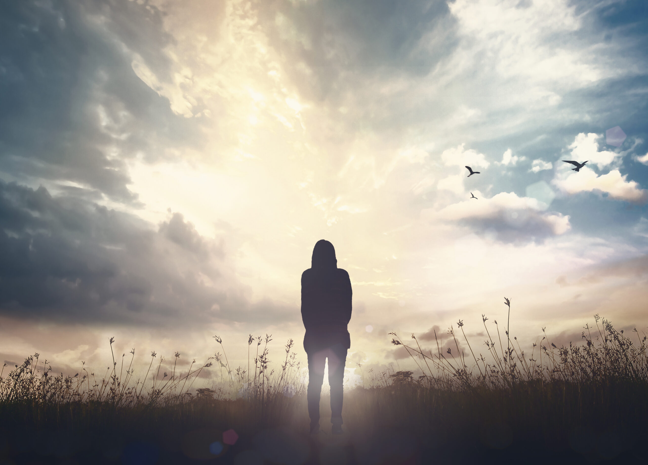 woman standing in front of the blue sky referring spiritual vibes, featured image of new episode called Mystery of Death and Life After Life: Where Do We Go When We’re Done Here? With Christopher Kerr MD, Ph.D. & Mike Anthony