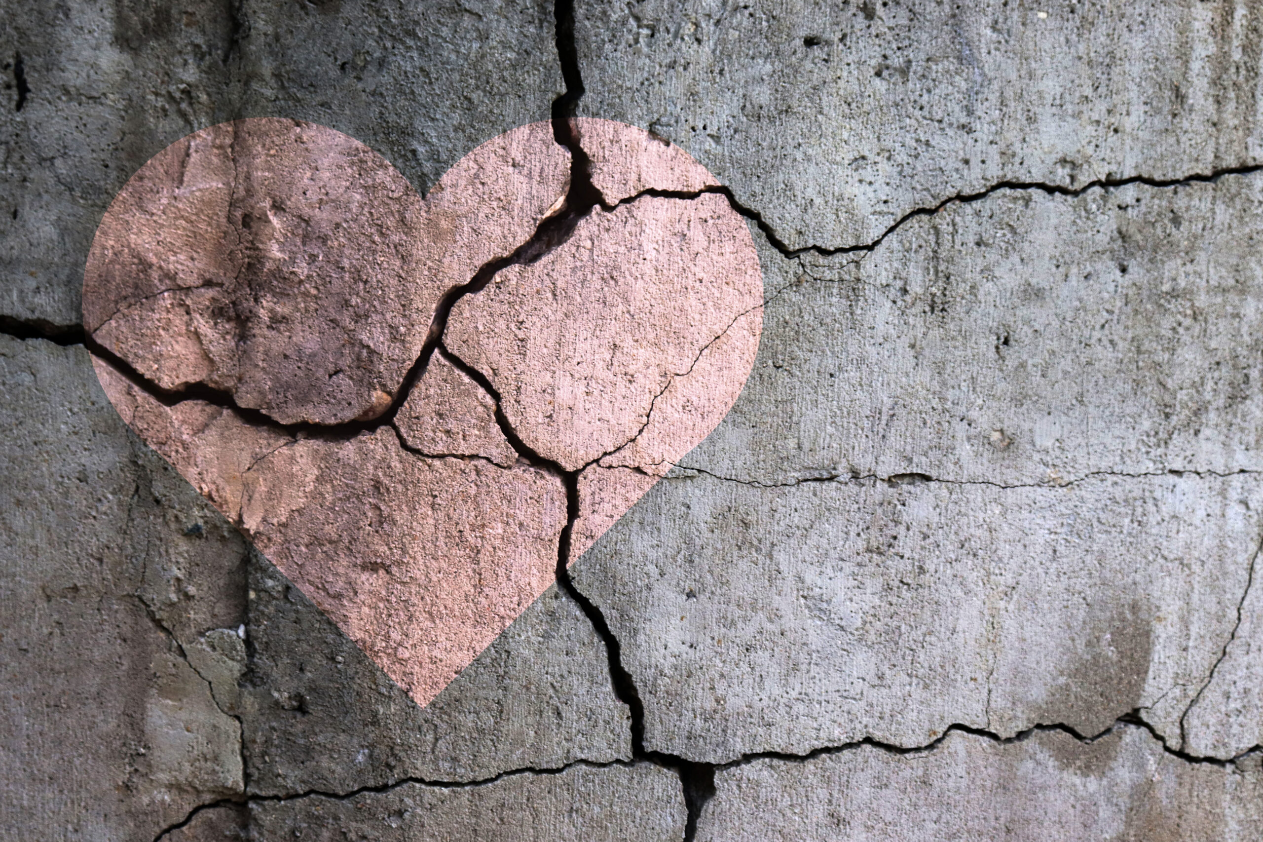Broken pink heart with a gray background, image of new podcast episode about mind games and gaslighting with Deborah Vinall and Kristina Scharp