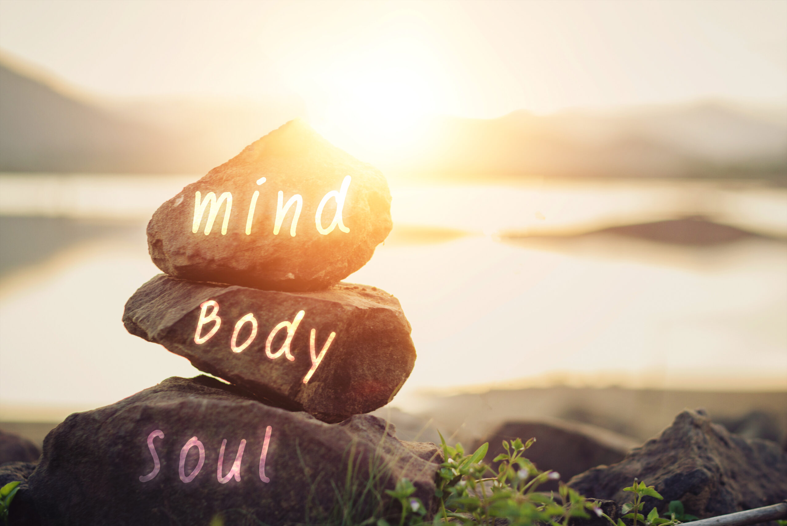 Rocks with the words mind, body, and soul on a bright background, image of new episode of Harvesting Happiness Talk Radio about health & happiness with Lisa Cypers Kamen, Agapi Stassinopoulos & Valentina Onisor.