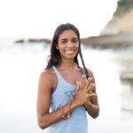 Daya Grant Ph.D. with blue shirt in the beach, guest of episode about smart moves, resilience and performance with Steve Magness.