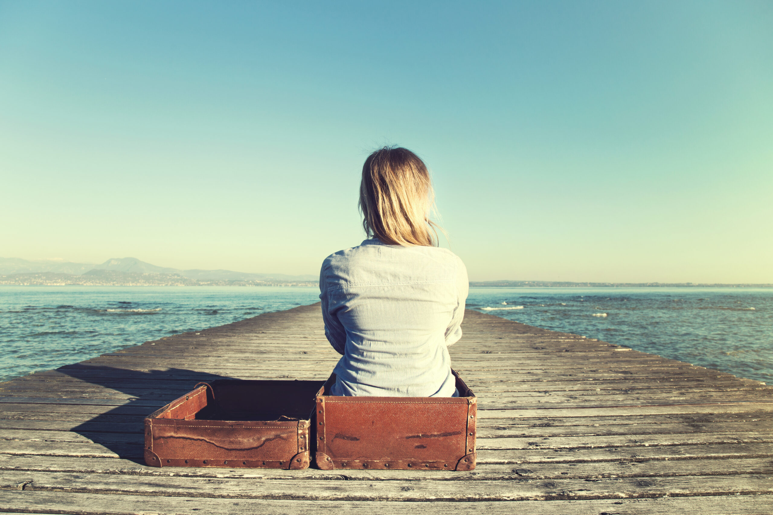 Woman watching the horizon, podcast episode about emotional baggage and trauma with Galit Atlas Ph.D. & Elizabeth Rosner